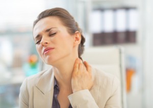 Portrait of business woman with neck ache